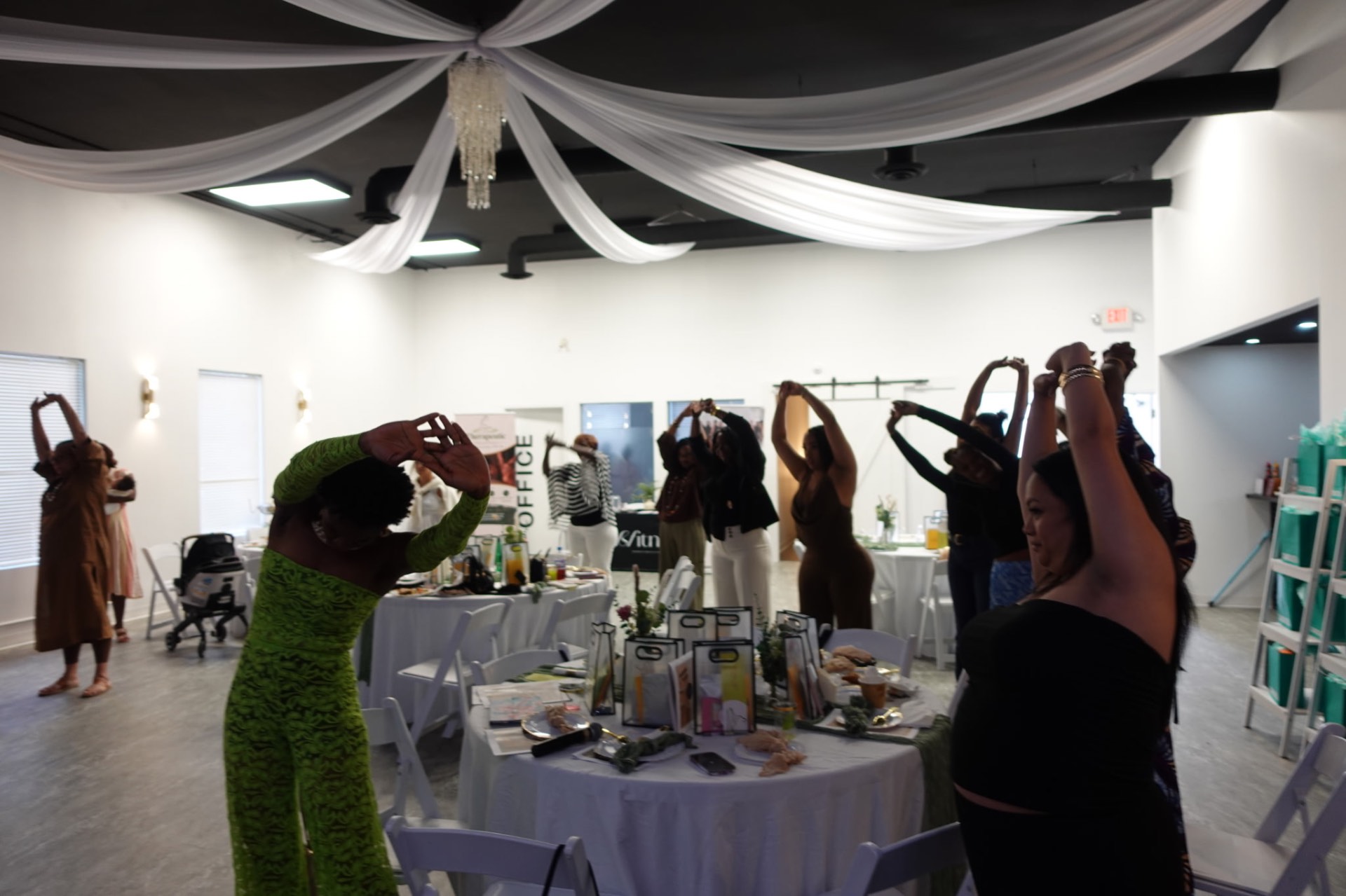 Wide view of the room mid-stretch around styled tables