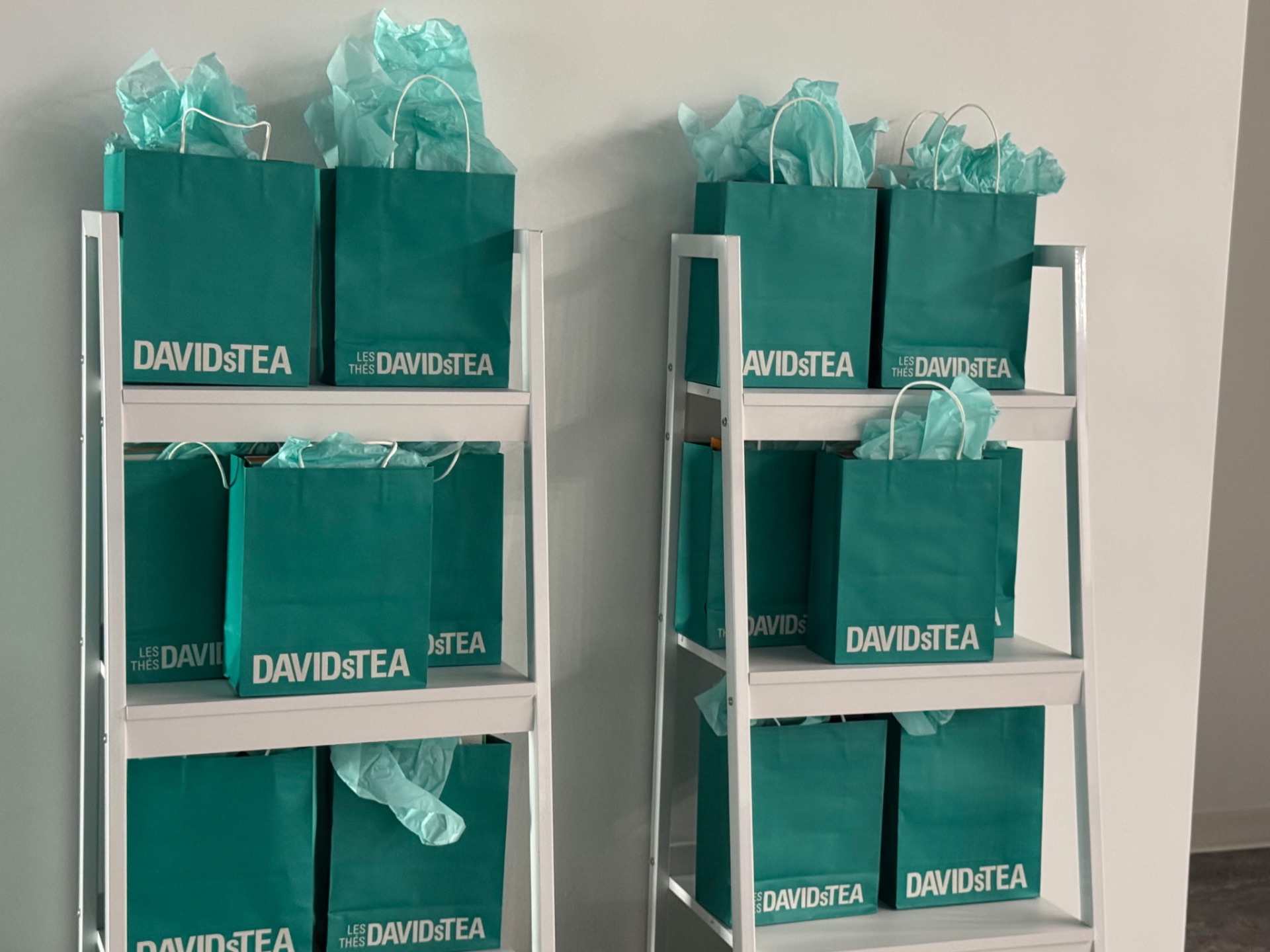 Close view of curated gift bags on white shelving