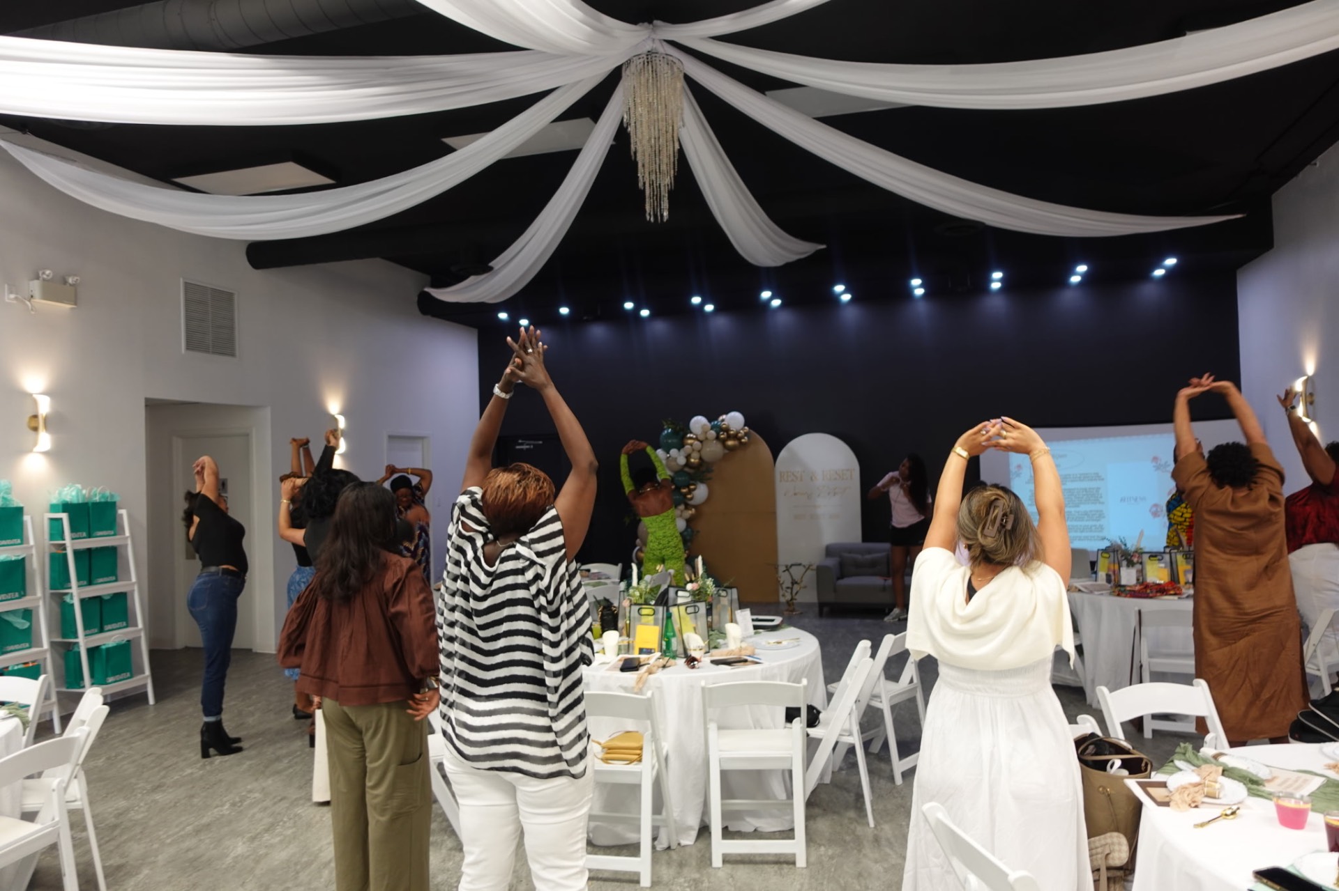 Guests raising their arms during the group movement session