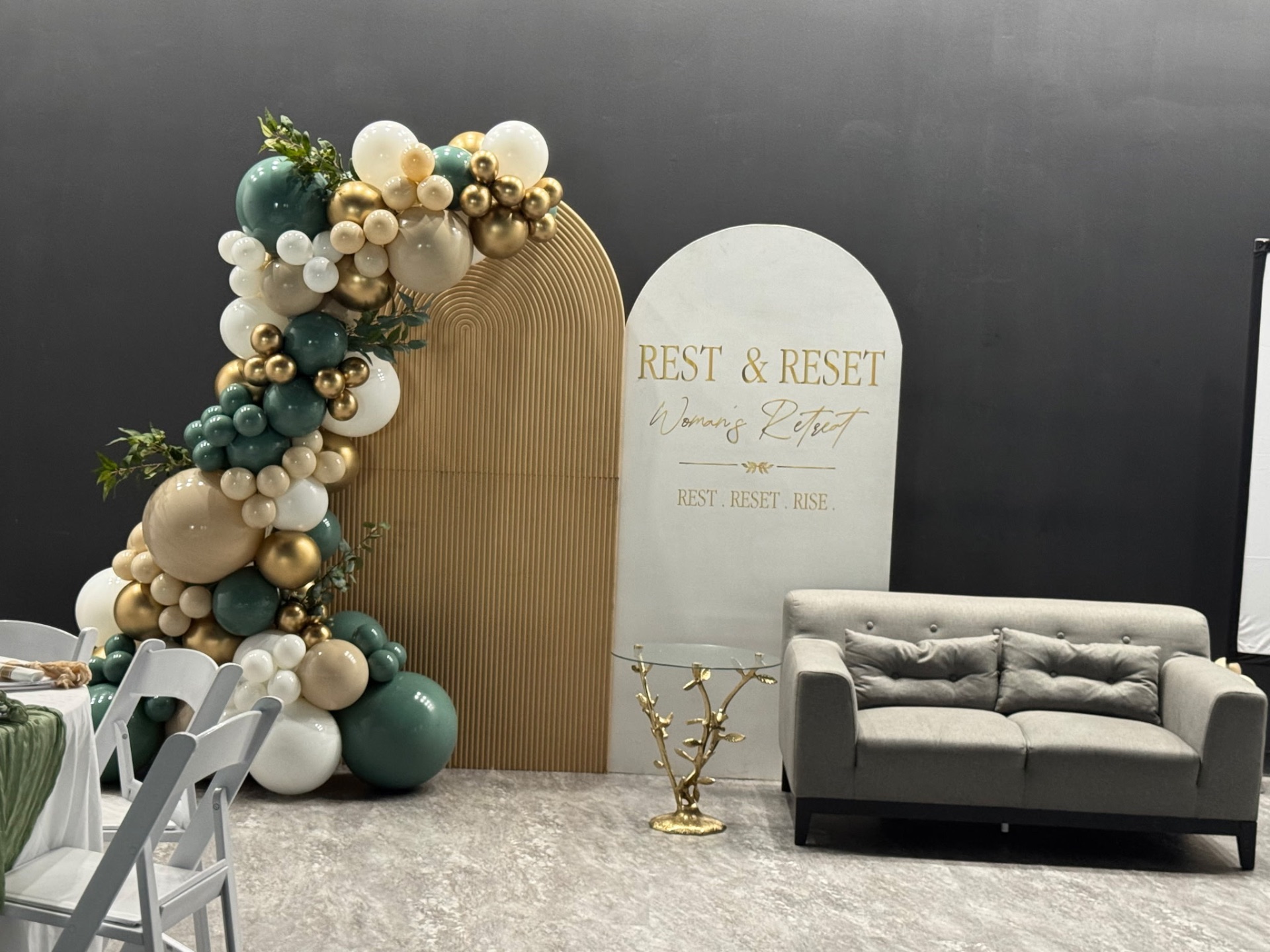 Retreat backdrop and lounge seating with gold accent table