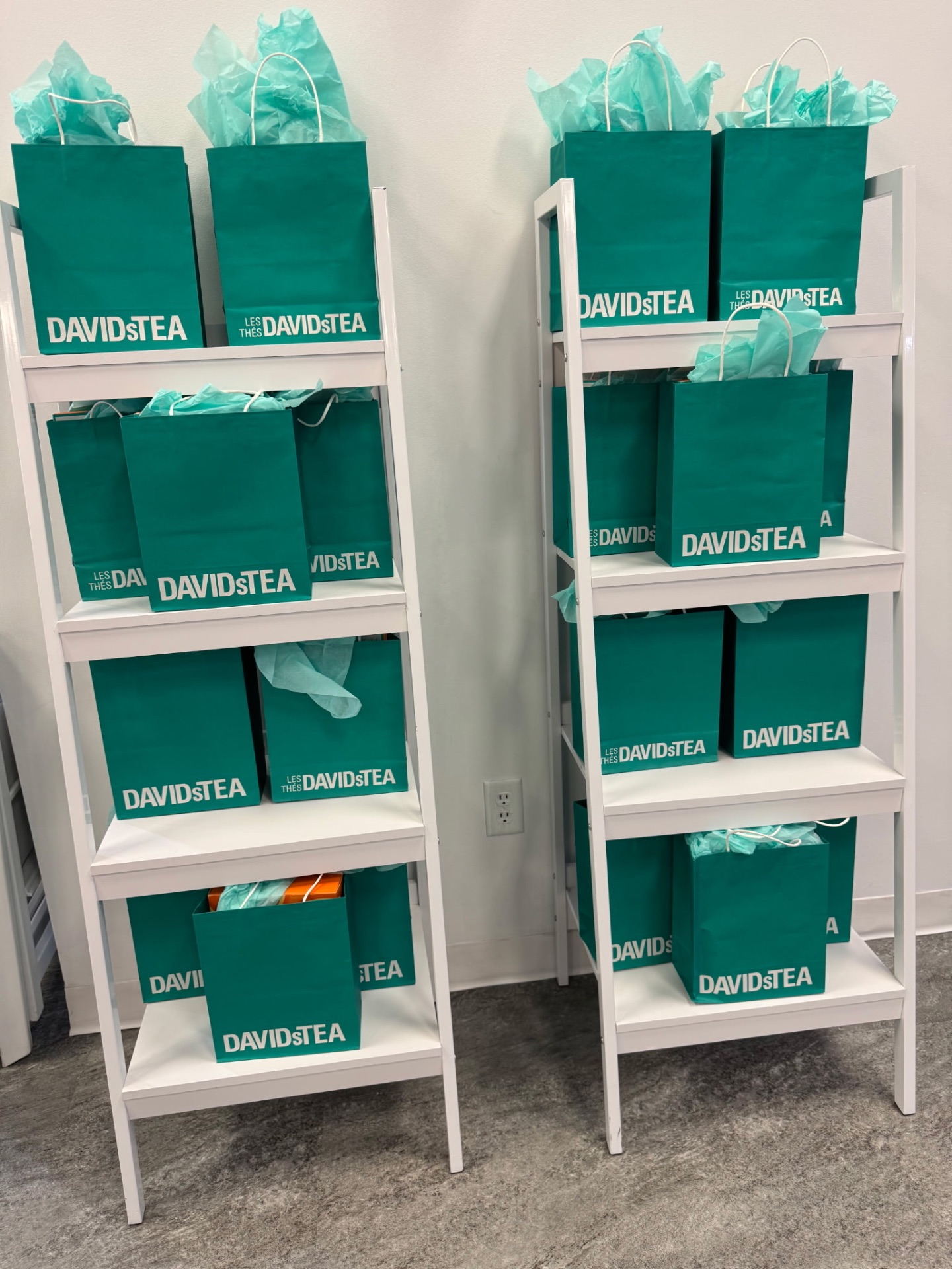 Shelves of teal gift bags prepared for retreat guests