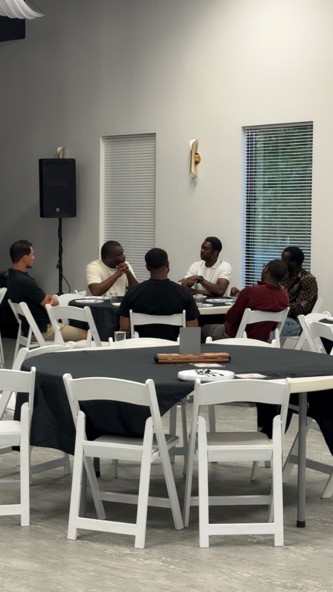 A group of men talking across the table during the lounge night